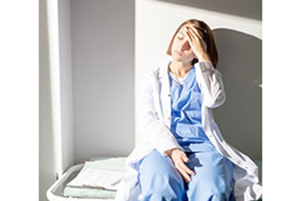 Exhausted Nurse Or Assistant In Whitecoat And Uniform Suffering From Headache